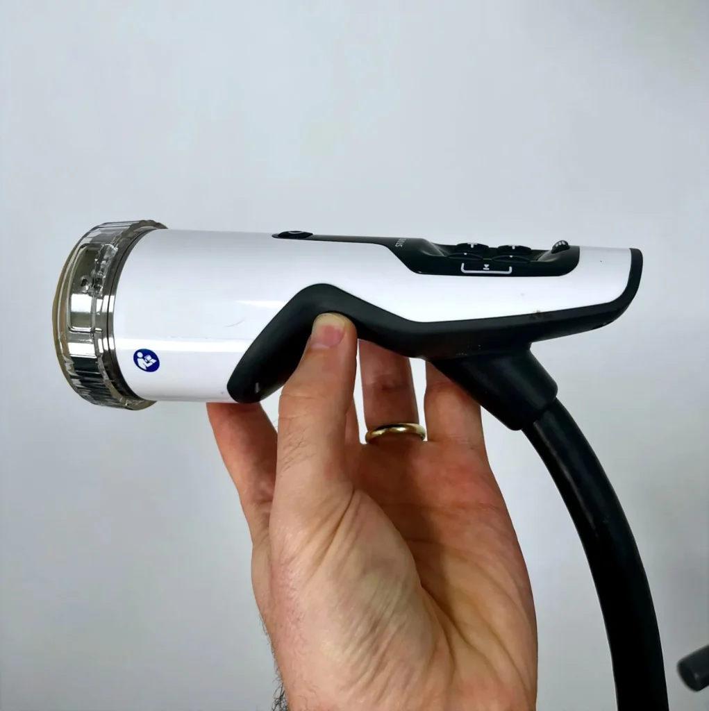A physiotherapist holding a Storz Medical Duolith SD1 focused shockwave therapy handpiece in Holland Park West.